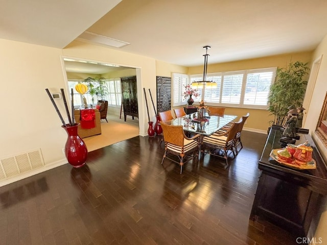 dining space featuring wood finished floors, visible vents, plenty of natural light, and baseboards