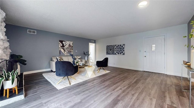 sitting room featuring visible vents, wood finished floors, and baseboards