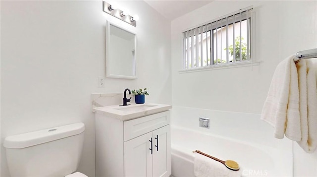 full bath featuring toilet, a bath, and vanity