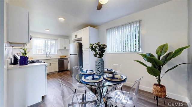 dining room with recessed lighting, wood finished floors, and baseboards