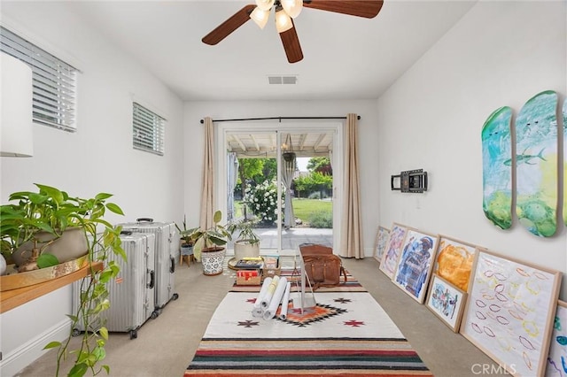 dining space featuring visible vents, a ceiling fan, and light colored carpet