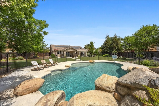 view of swimming pool featuring fence, a patio area, a lawn, and a fenced in pool
