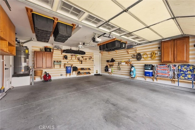 garage featuring a garage door opener and water heater