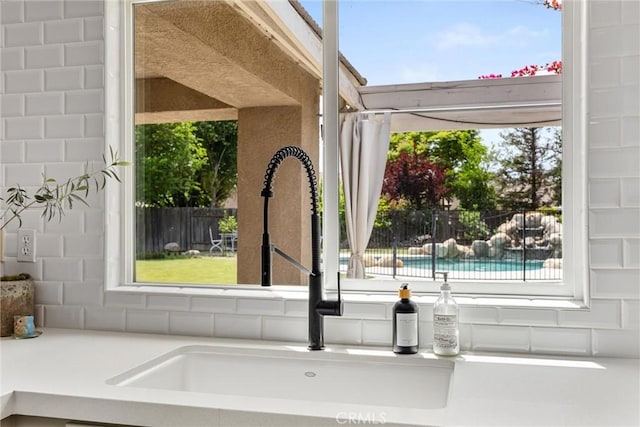 interior details with a sink and light countertops