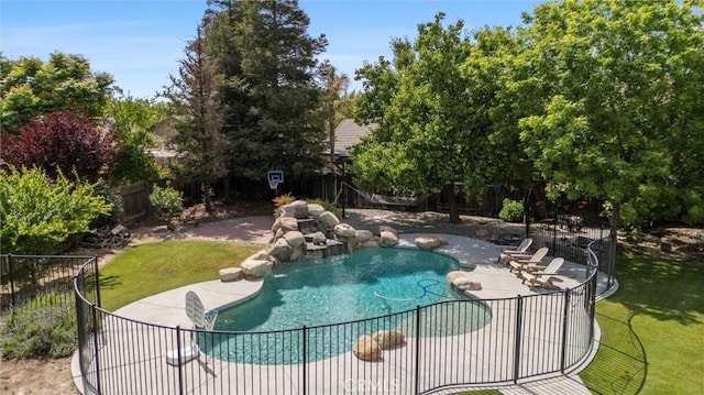 view of swimming pool featuring a lawn, a patio area, a fenced in pool, and a fenced backyard
