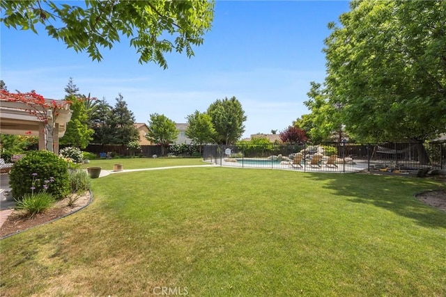 view of yard with a pergola, a fenced in pool, and fence