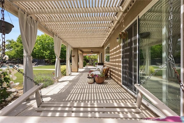 view of patio / terrace with covered porch, ceiling fan, and a pergola