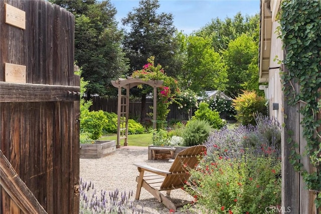 exterior space featuring fence and a vegetable garden