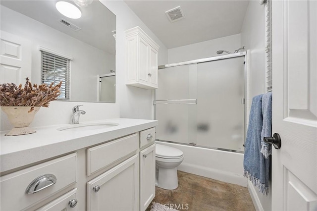 full bath with toilet, visible vents, vanity, and enclosed tub / shower combo
