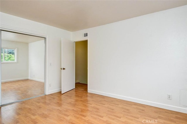 interior space featuring visible vents, baseboards, and light wood-style floors
