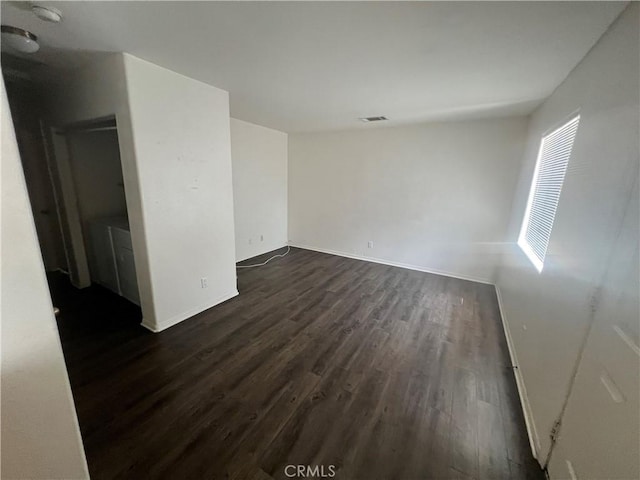 6320 Mesquite Ave Unit 29, Palms, CA 92277 - empty room with dark wood-style floors, visible vents, and baseboards