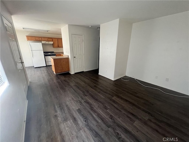 6320 Mesquite Ave Unit 29, Palms, CA 92277 - unfurnished living room with dark wood-type flooring and baseboards