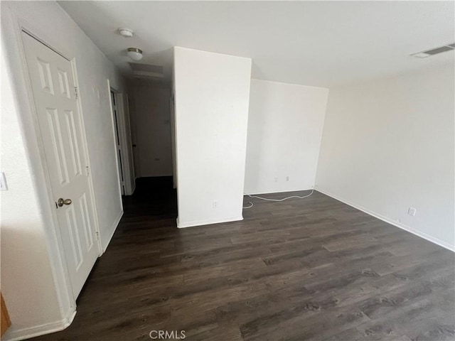 6320 Mesquite Ave Unit 29, Palms, CA 92277 - empty room with visible vents, baseboards, and dark wood-type flooring