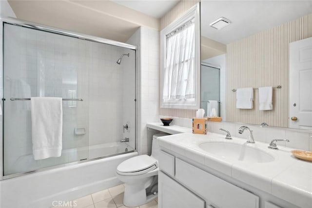 full bathroom with tile patterned floors, wallpapered walls, toilet, vanity, and visible vents