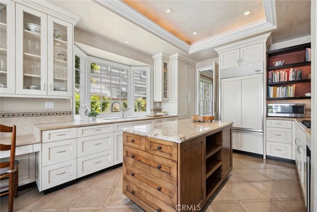 kitchen featuring stainless steel microwave, white cabinets, and open shelves