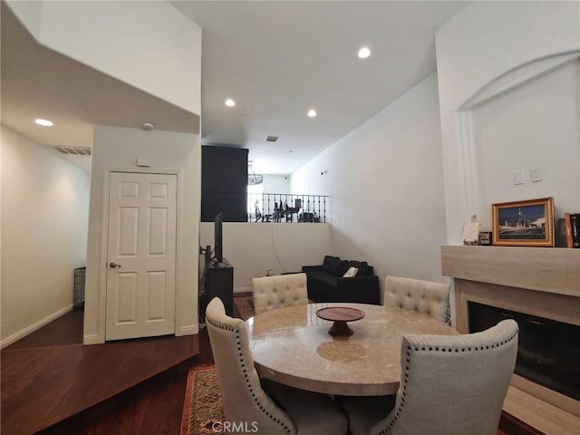dining space with dark wood-type flooring, recessed lighting, and baseboards