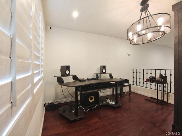 dining area with wood finished floors, a chandelier, a desk, and baseboards