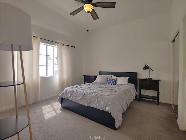 carpeted bedroom featuring baseboards and a ceiling fan