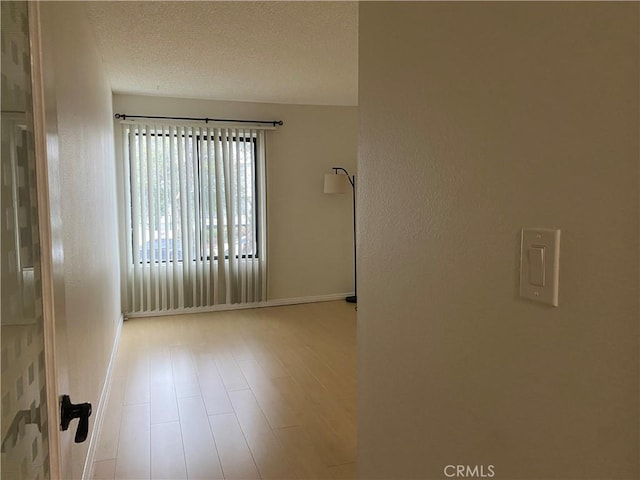 21040 Parthenia St Unit 13, Canoga Park, CA 91304 - spare room featuring baseboards, a textured ceiling, and wood finished floors