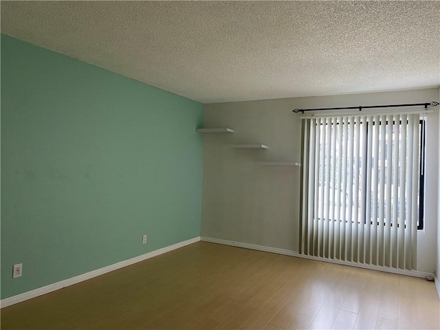 21040 Parthenia St Unit 13, Canoga Park, CA 91304 - spare room featuring wood finished floors, a textured ceiling, and baseboards