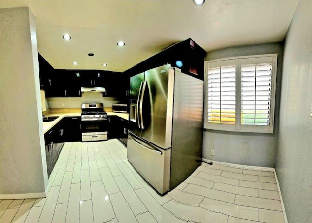 21040 Parthenia St Unit 13, Canoga Park, CA 91304 - kitchen featuring stainless steel range with gas cooktop, refrigerator with ice dispenser, dark cabinets, under cabinet range hood, and recessed lighting