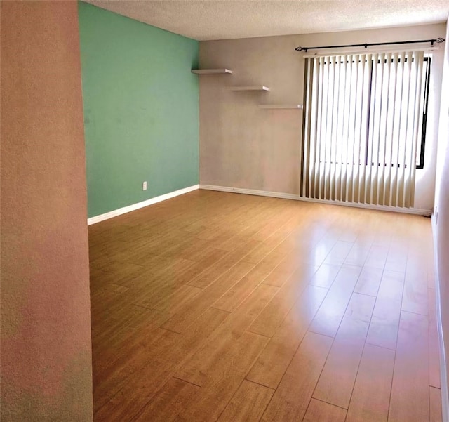 21040 Parthenia St Unit 13, Canoga Park, CA 91304 - unfurnished room with wood finished floors, a textured ceiling, and baseboards