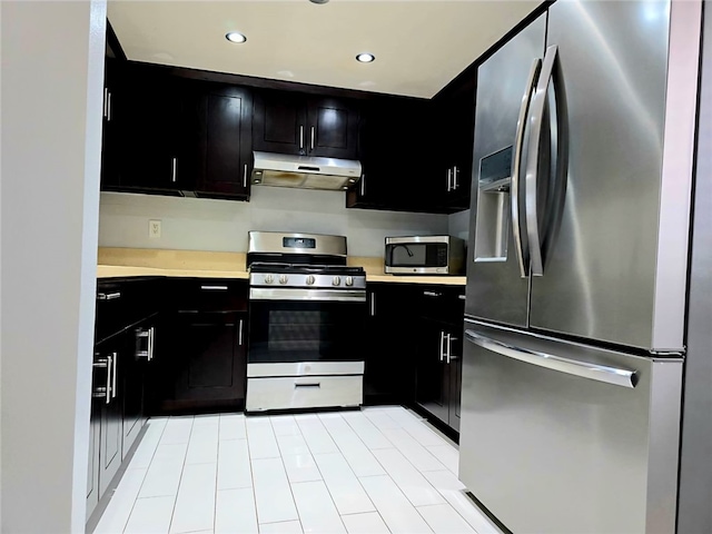 21040 Parthenia St Unit 13, Canoga Park, CA 91304 - kitchen with stainless steel appliances, under cabinet range hood, dark cabinets, light countertops, and recessed lighting