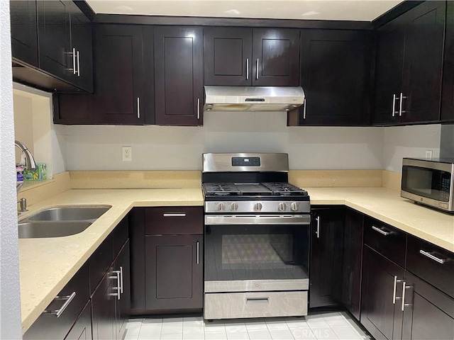 21040 Parthenia St Unit 13, Canoga Park, CA 91304 - kitchen featuring stainless steel appliances, under cabinet range hood, a sink, and light tile patterned flooring