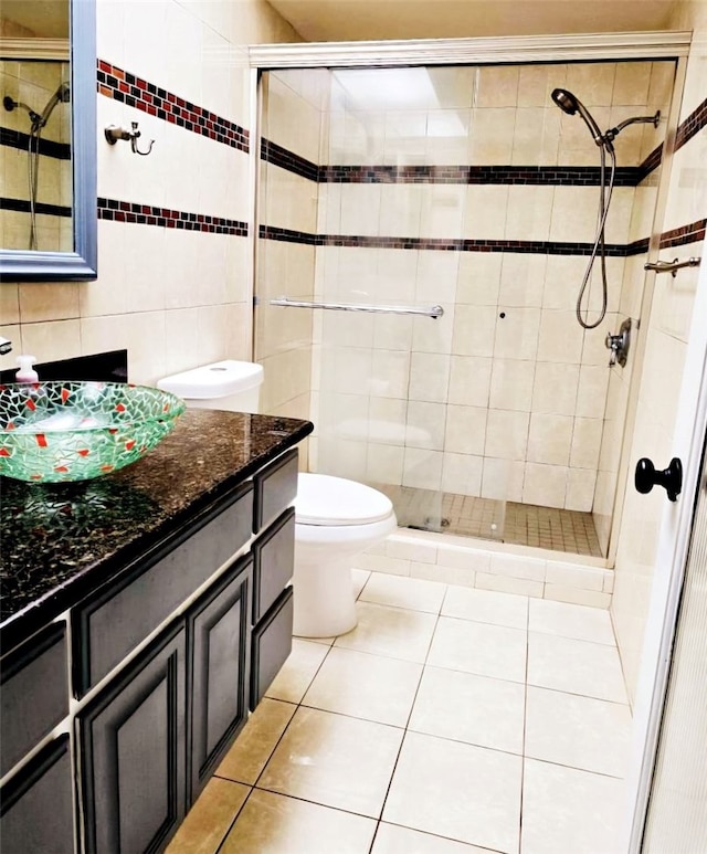 21040 Parthenia St Unit 13, Canoga Park, CA 91304 - bathroom with tile walls, vanity, tile patterned floors, toilet, and a shower stall