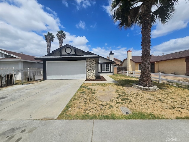 single story home featuring fence, an attached garage, driveway, and stone siding