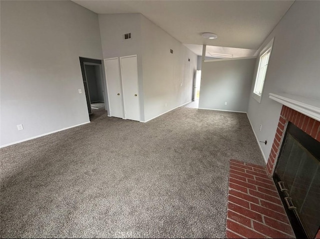 unfurnished living room featuring visible vents, a brick fireplace, lofted ceiling, baseboards, and carpet