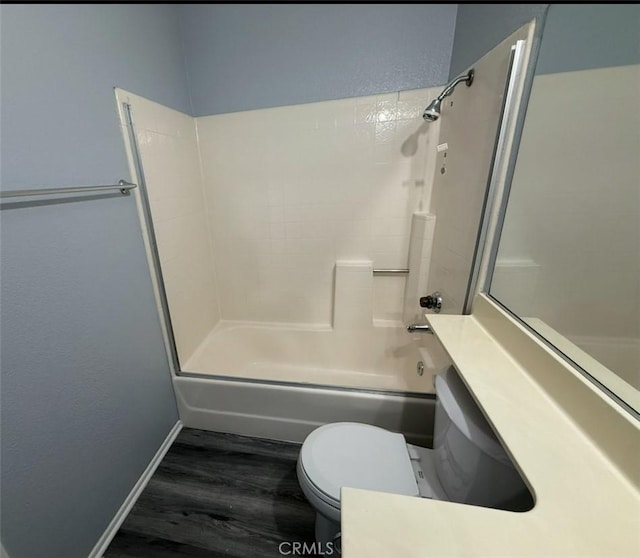 full bathroom with vanity, toilet, baseboards, bathing tub / shower combination, and wood finished floors