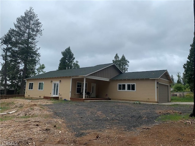 back of property with an attached garage