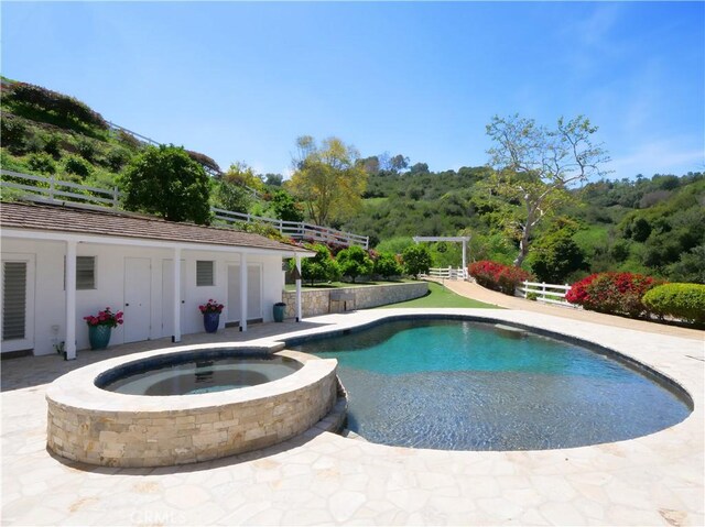 3 Poppy Trl, Rolling Hills, CA 90274 - view of pool featuring a view of trees, fence, and a pool with connected hot tub
