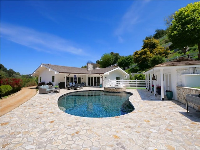 3 Poppy Trl, Rolling Hills, CA 90274 - view of swimming pool featuring a patio, a pool with connected hot tub, fence, and an outdoor hangout area