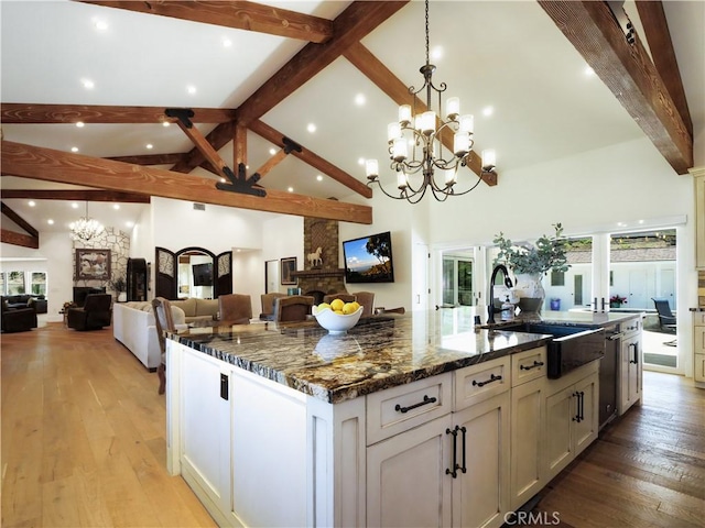 3 Poppy Trl, Rolling Hills, CA 90274 - kitchen with beam ceiling, a stone fireplace, open floor plan, a spacious island, and a sink
