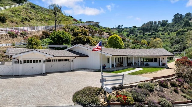 3 Poppy Trl, Rolling Hills, CA 90274 - ranch-style house featuring an attached garage, decorative driveway, fence, and a porch