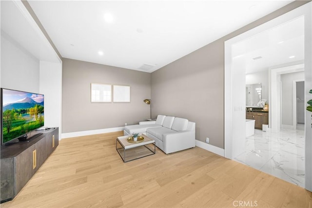 unfurnished living room with baseboards and recessed lighting