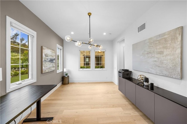 unfurnished dining area featuring light wood-style floors, a healthy amount of sunlight, recessed lighting, and visible vents