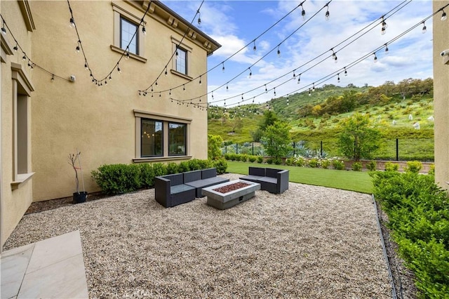 exterior space with an outdoor living space with a fire pit