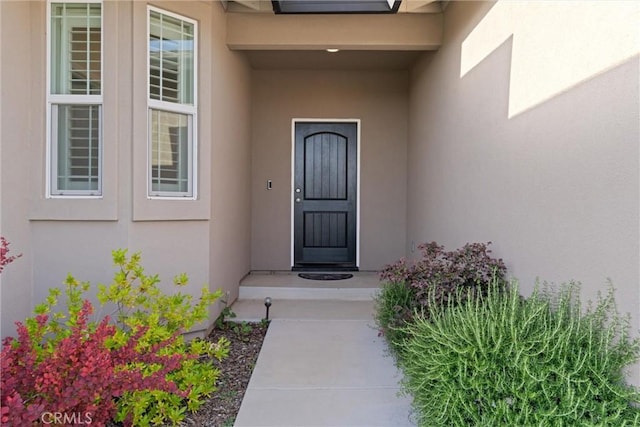 property entrance featuring stucco siding