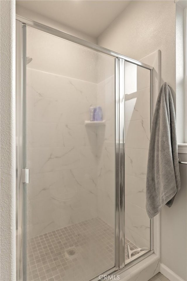 full bath featuring a shower stall