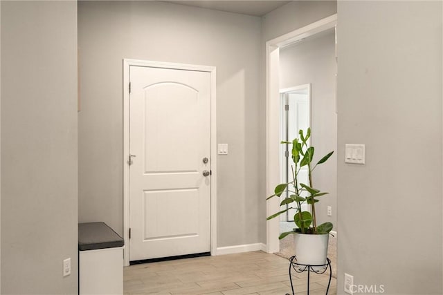 entrance foyer with baseboards and light wood-type flooring