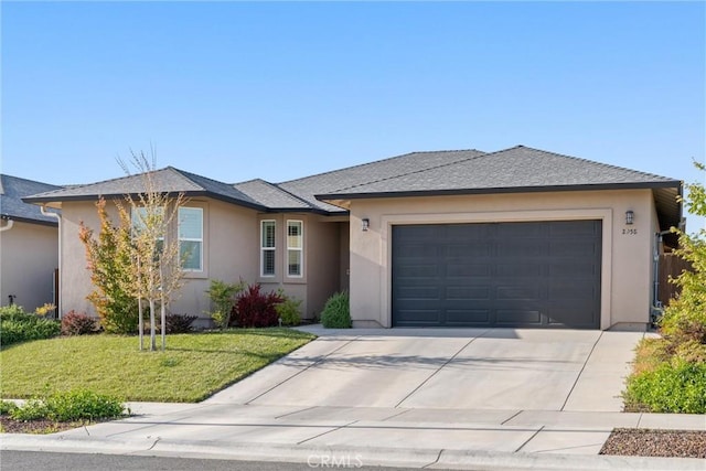 2958 Beaumont Ave, Chico, CA 95928 - view of front facade with concrete driveway, stucco siding, a front lawn, and an attached garage