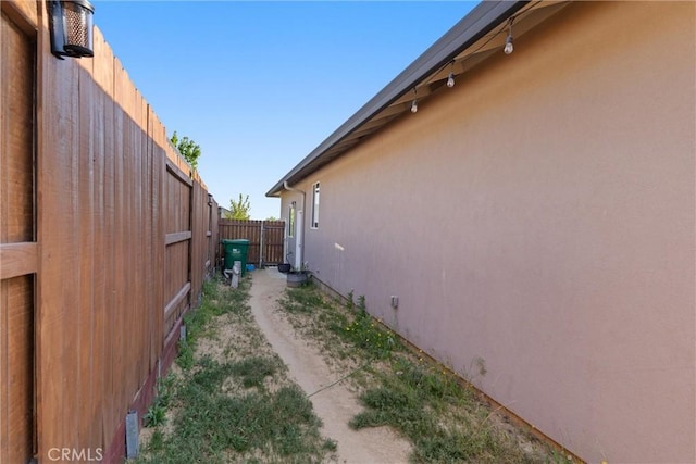 view of property exterior with fence and stucco siding