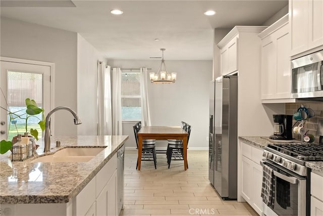 2958 Beaumont Ave, Chico, CA 95928 - kitchen featuring white cabinetry, appliances with stainless steel finishes, a chandelier, and a sink