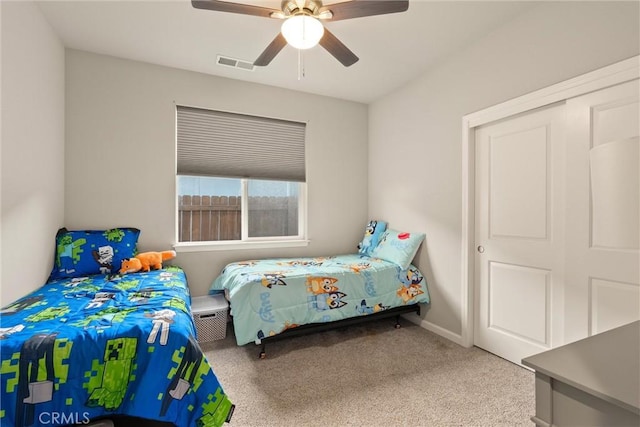 bedroom featuring carpet flooring, a ceiling fan, and visible vents