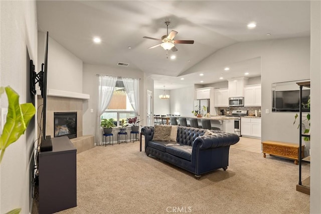 2958 Beaumont Ave, Chico, CA 95928 - living area with lofted ceiling, visible vents, light carpet, a ceiling fan, and a tile fireplace