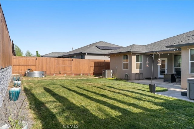 view of yard featuring central AC, a patio, and a fenced backyard