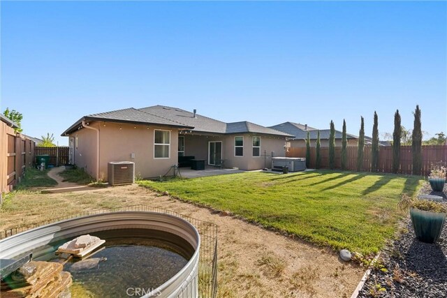 2958 Beaumont Ave, Chico, CA 95928 - rear view of house featuring a hot tub, a patio, stucco siding, a fenced backyard, and central AC unit
